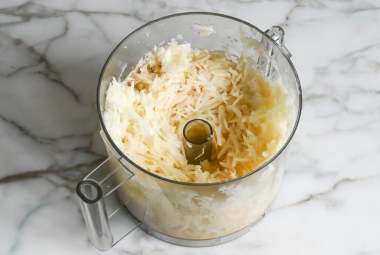 shredded potato and onion mixture in food processor