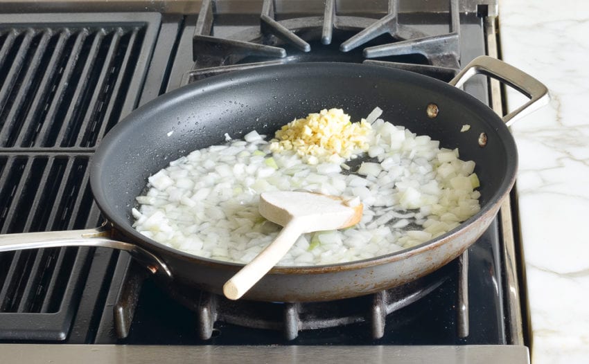 Garlic in a skillet with onions.
