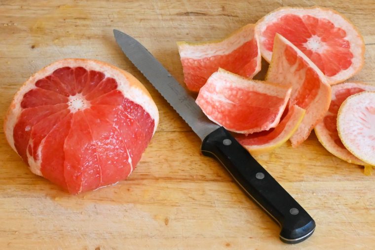 cutting the skin and pith off of the grapefruit