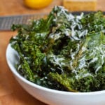 Bowl of kale chips with lemon and parmesan.