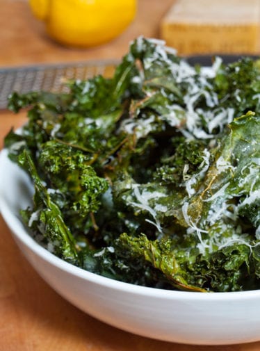 Bowl of kale chips with lemon and parmesan.