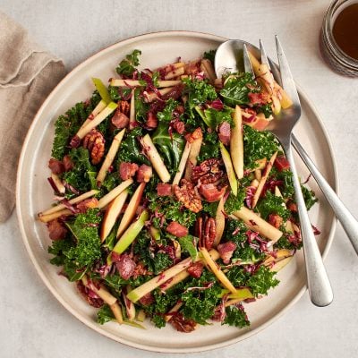 kale, apple, and pancetta salad on plate