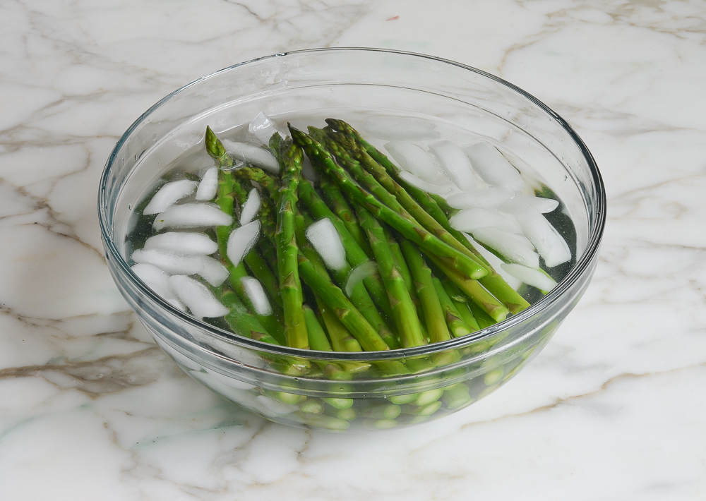 shocking the asparagus in ice cold water