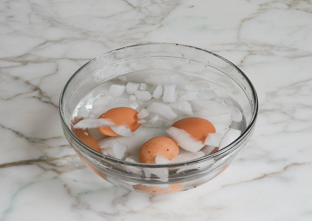 cooling the eggs in an ice bath