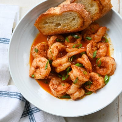 Bread in a bowl with New Orleans-inspired barbeque shrimp.