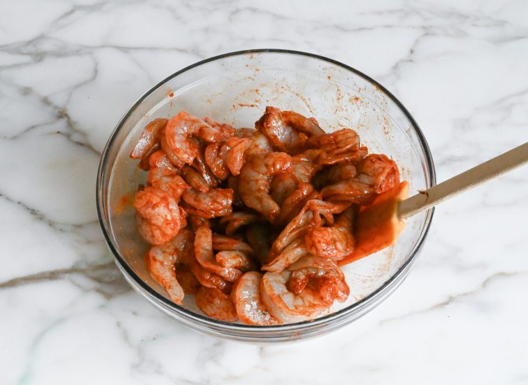 tossing shrimp with spices