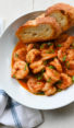 Bread in a bowl with New Orleans-inspired barbeque shrimp.