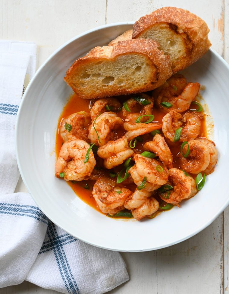 Bread in a bowl with New Orleans-inspired barbeque shrimp.