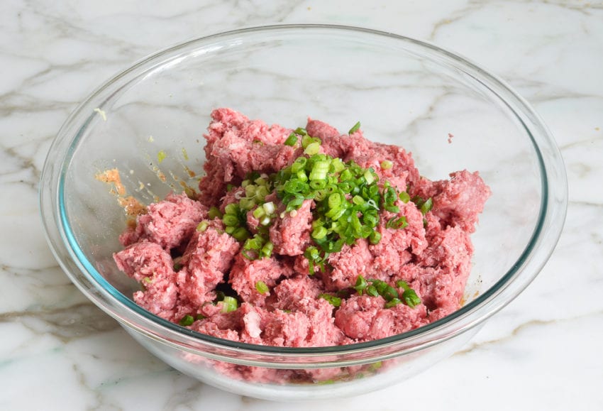 adding ground beef and scallions to panade