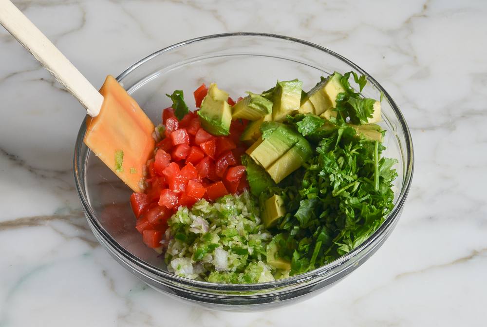 ingredients for avocado salsa in mixing bowl