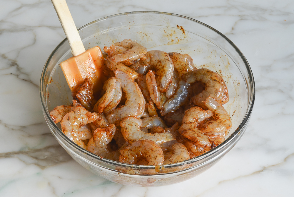 shrimp tossed with seasoning, ready to grill