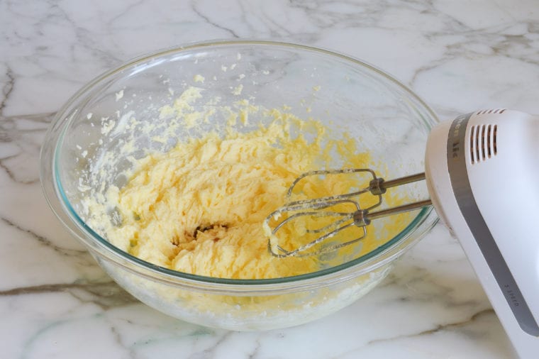 Vanilla added to a bowl with a butter mixture.