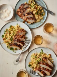Grilled Moroccan Chicken sliced on plate with couscous.