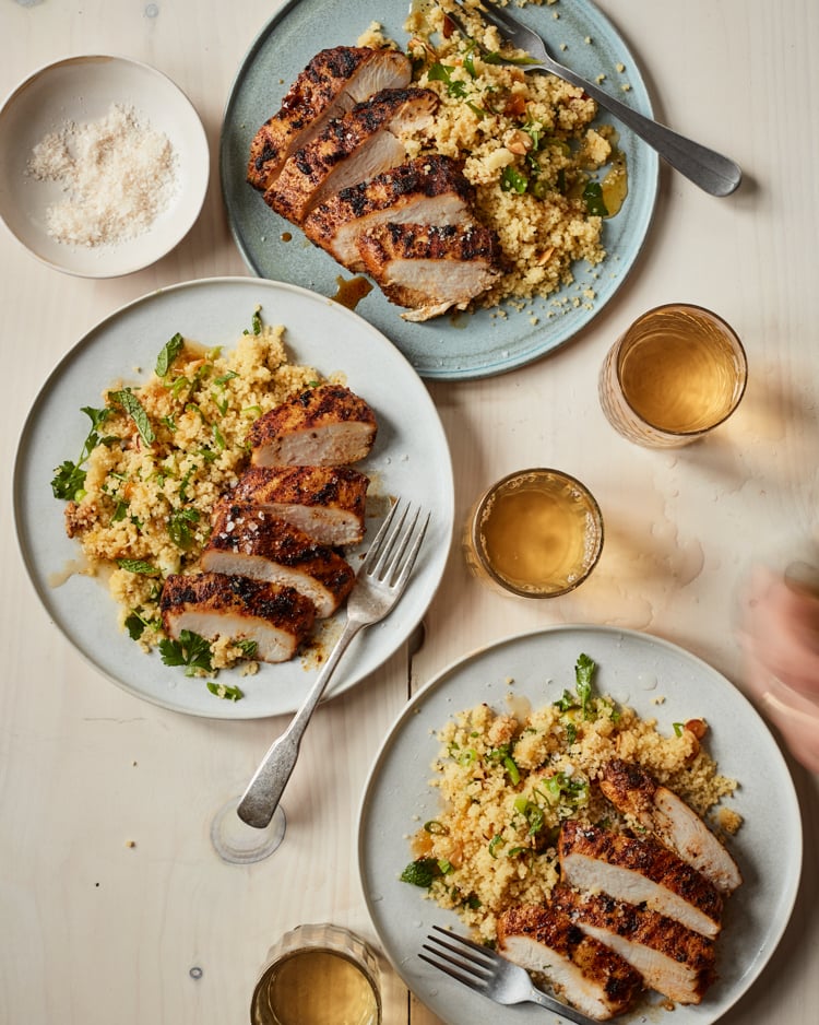 Grilled Moroccan Chicken sliced on plate with couscous.