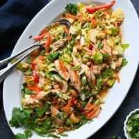 Spoons in a platter of Chinese chicken salad.