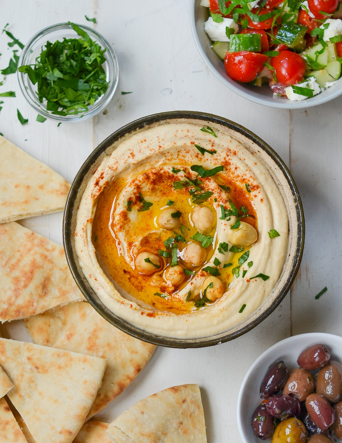Bowl of hummus topped with whole chickpeas.