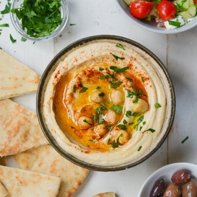 Bowl of hummus topped with whole chickpeas.