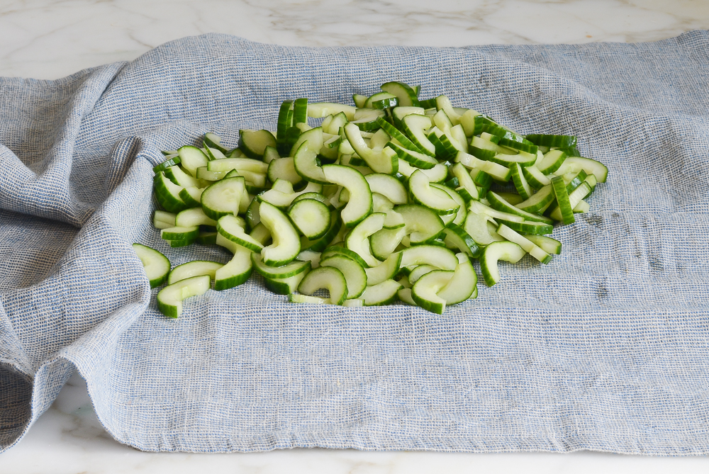 sliced cucumbers on dish towel