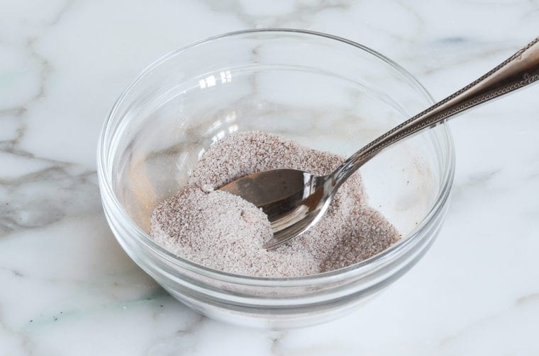 Spoon in a bowl of cinnamon and sugar.