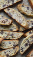 Slices of chocolate chip Mandel bread on parchment paper.