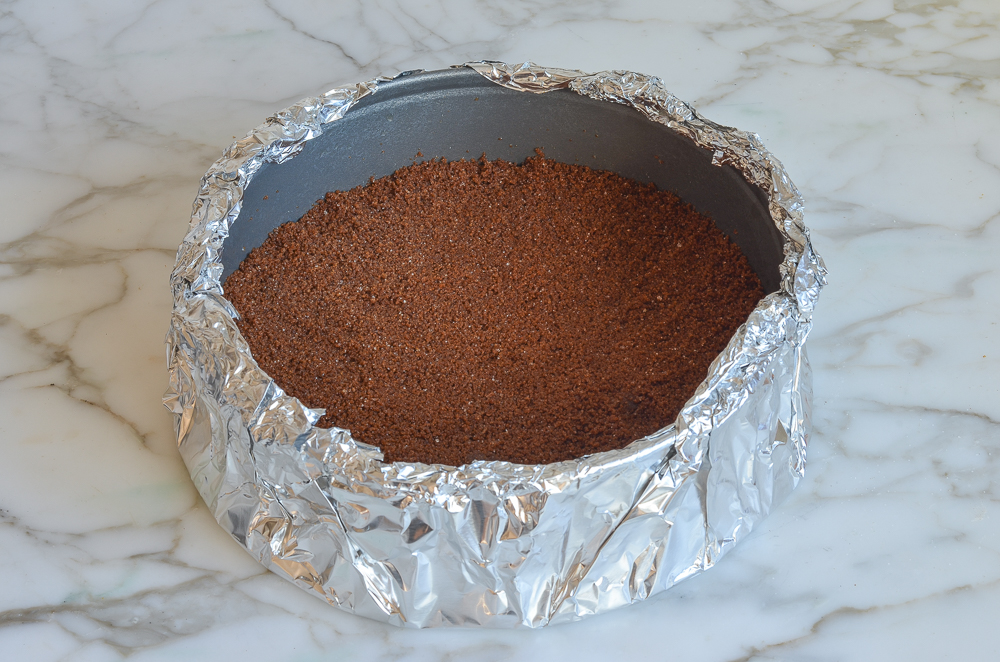 Foil-wrapped pan with a ginger snap crust.