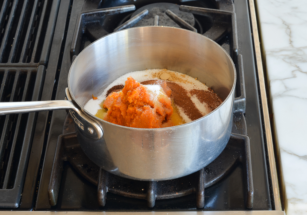 Pumpkin, sugar, and spices in a pan.