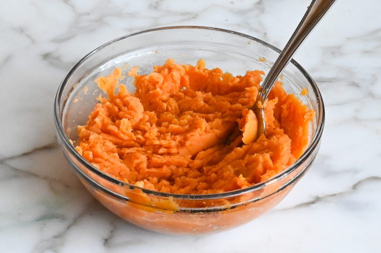 mashing sweet potatoes with a fork