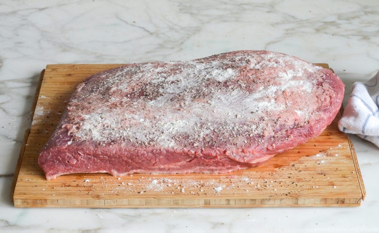 dusting the brisket with flour
