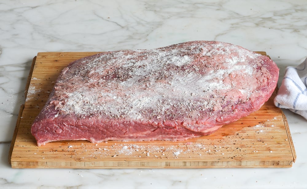 dusting the brisket with flour