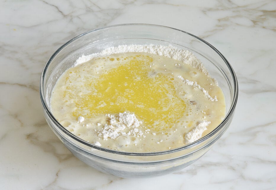 Bowl with butter, dry ingredients, and banana mixture.