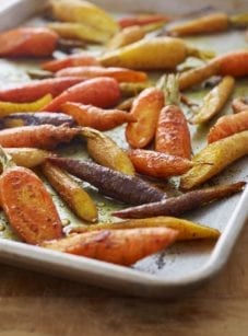 Curried roasted carrots on a baking tray.