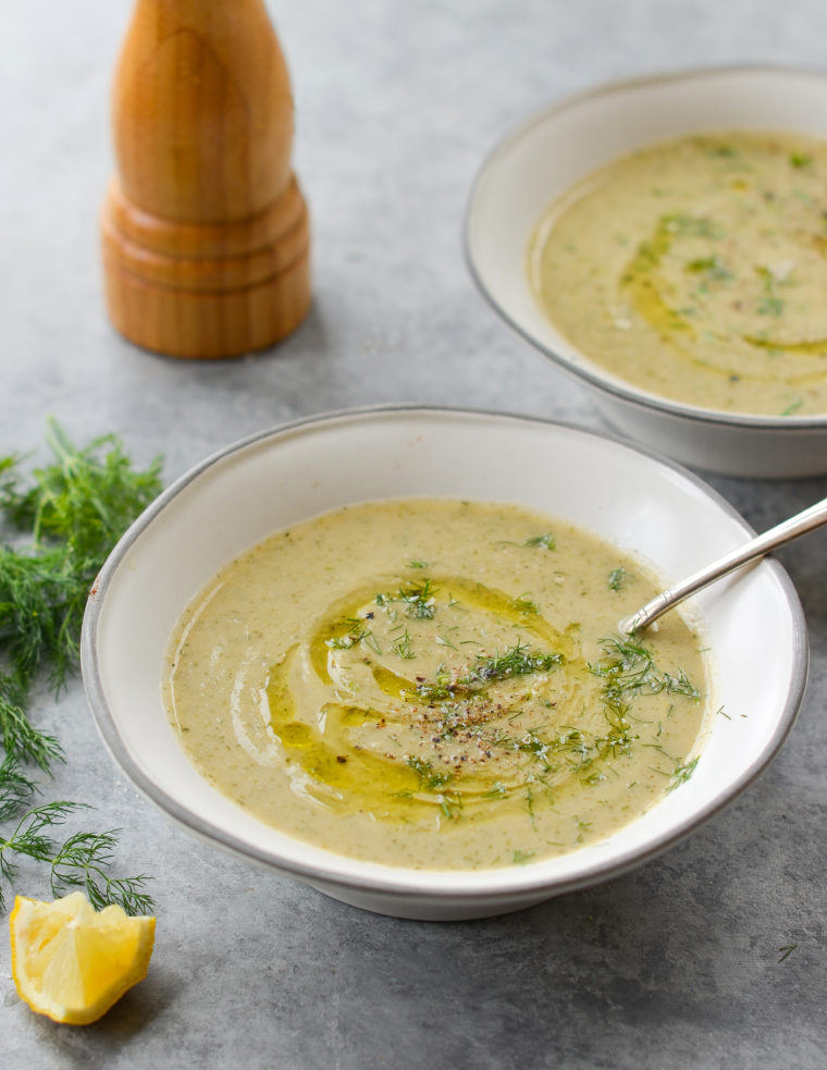 Spoon in a bowl of zucchini soup.