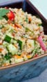 Thai quinoa salad with fresh herbs and lime vinaigrette in a square bowl.