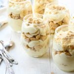 Multiple wine glasses of banana pudding parfaits.
