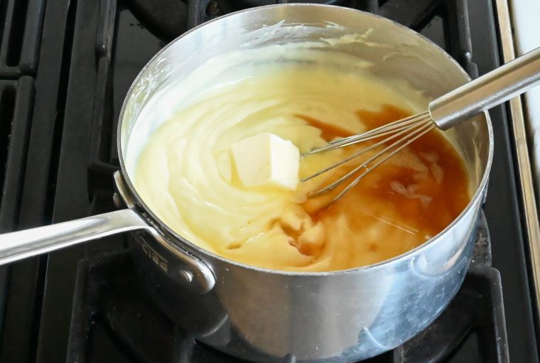 whisking in the vanilla, butter, and rum