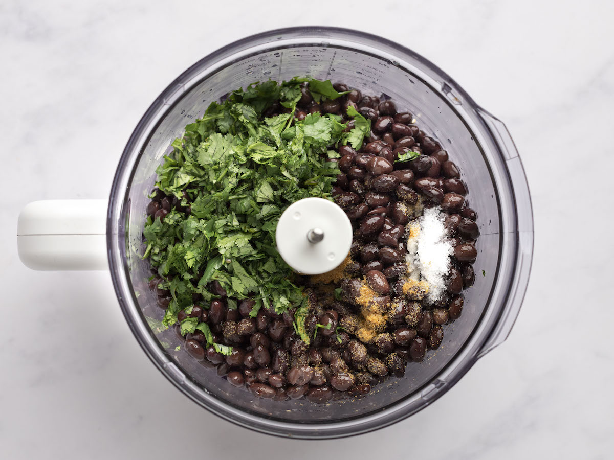 Beans with onion mixture, salt, cumin, lime juice, water, and fresh cilantro in a food processor.