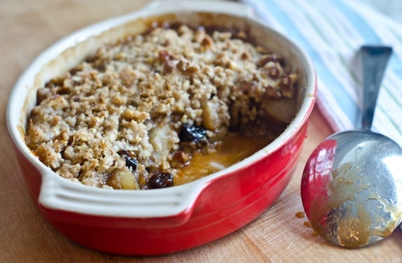 Baking dish of pear and dried cherry crisp with walnut streusel.