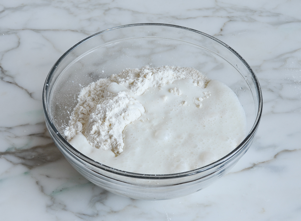 adding buttermilk to biscuit dough