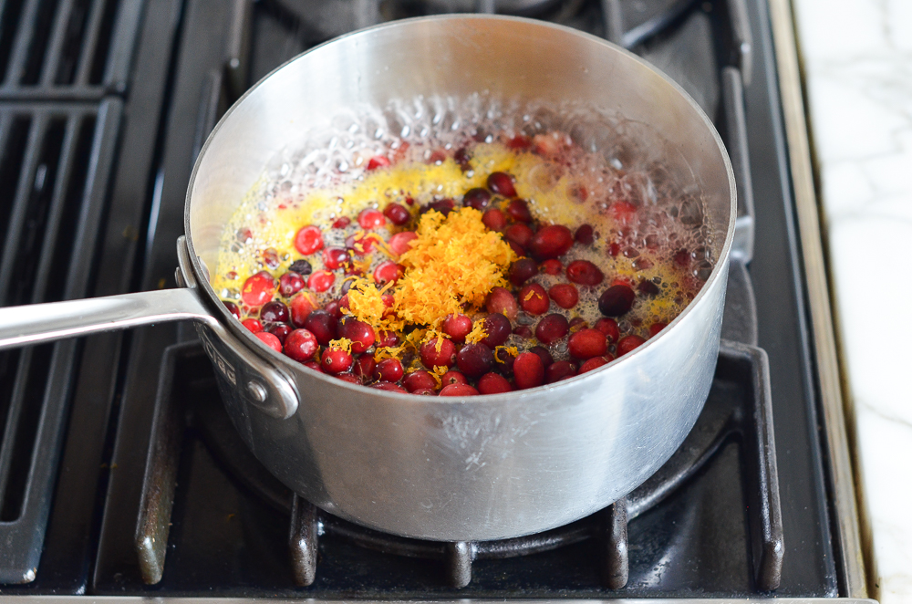 adding the cranberries, zest, and salt to the pot
