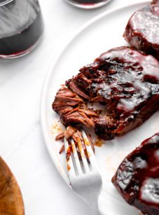 Fork on a plate with slow-baked barbeque short ribs.