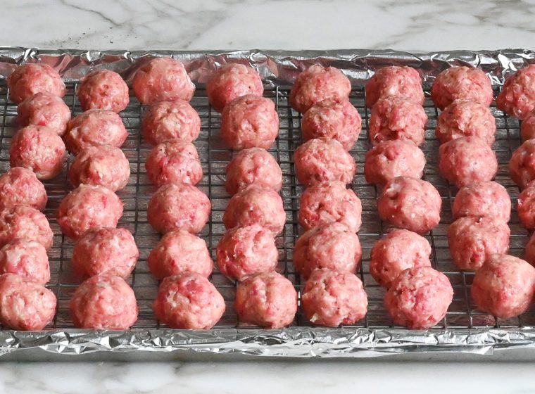 meatballs on rack over baking sheet
