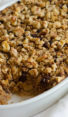 Baking dish of Amish-style baked oatmeal with apples, raisins, and walnuts.