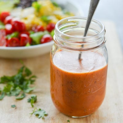Glass jar of copycat Chipotle's chipotle honey vinaigrette.