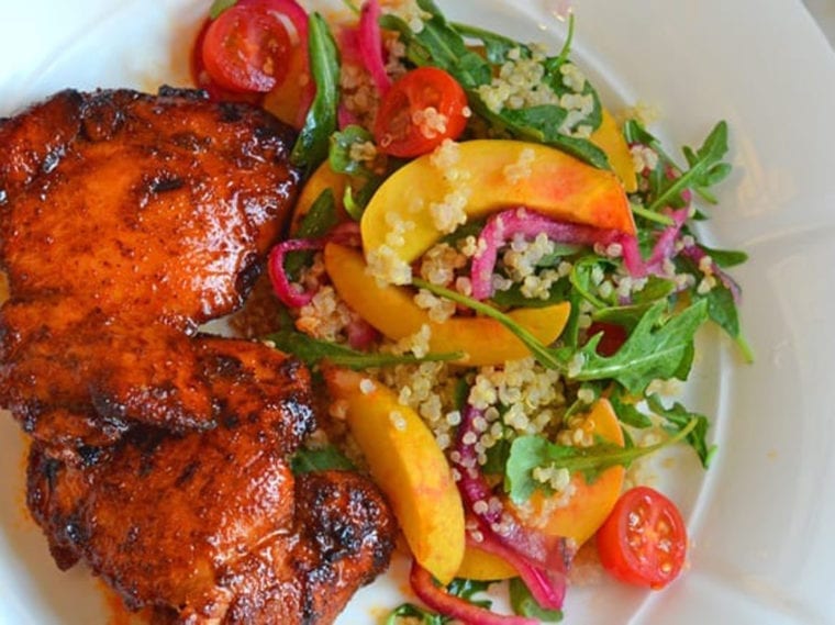 Spicy chicken thighs on a plate with salad.
