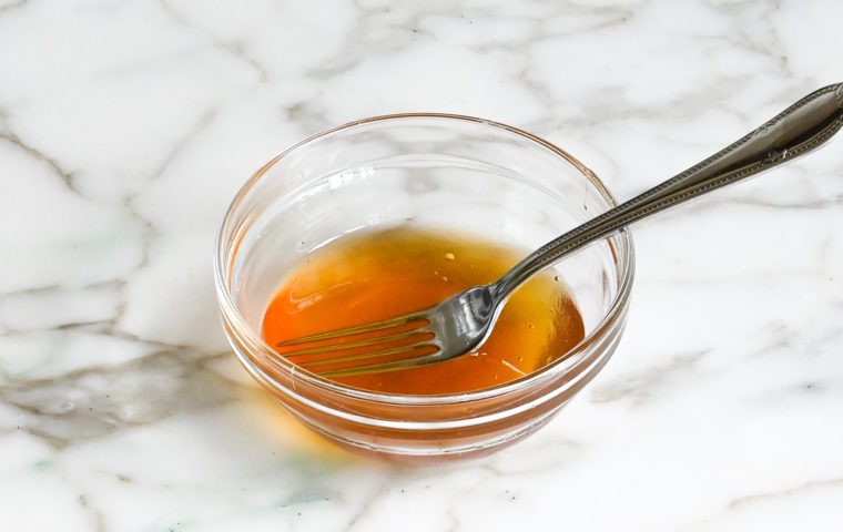 tangy honey glaze in a small bowl with a fork