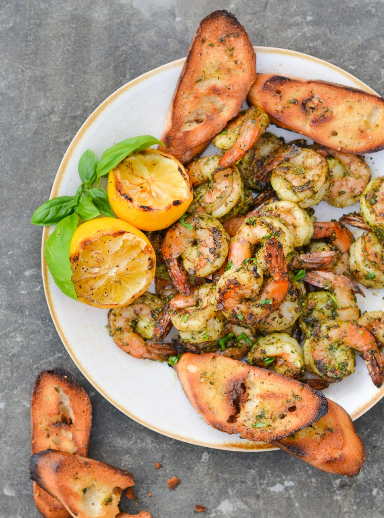 Plate of grilled shrimp with pesto.