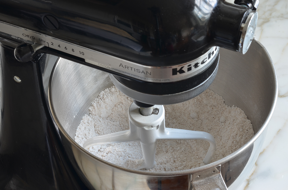 Flour, sugars, baking powder and salt mixed together in mixer to make rum cake 