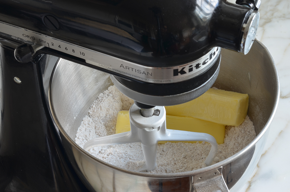 adding the butter to the mixer to make rum cake
