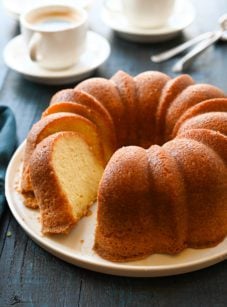 Partially-sliced run cake on a plate.