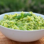 Bowl of creamed zucchini with garlic and basil.